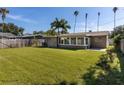 Expansive backyard featuring a lush green lawn and a privacy fence, perfect for outdoor activities and relaxation at 1836 Bayou Grande Ne Blvd, St Petersburg, FL 33703