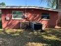 Backyard with a brick wall, grass, A/C unit, and a fence at 2110 Oakley S Ave, St Petersburg, FL 33712