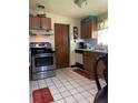 Traditional kitchen featuring stainless steel appliances, tile flooring and plenty of cabinets at 2110 Oakley S Ave, St Petersburg, FL 33712