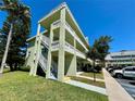 Exterior angled view of the condominium showing exterior staircase and balcony at 2460 Canadian Way # 36, Clearwater, FL 33763