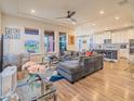 Comfortable living room with a sectional sofa, modern ceiling fan, and an open floor plan at 28923 Lucero Ln, Wesley Chapel, FL 33543