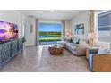 Inviting living room with a view of the outdoors, comfy seating, and entertainment setup at 3701 Stormy Thistle Pl, Plant City, FL 33565