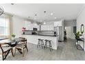 Modern kitchen featuring white cabinets, black countertops, stainless steel appliances, and bar seating at 4036 56Th N Ave, St Petersburg, FL 33714