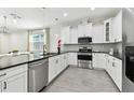Sleek kitchen with stainless steel appliances, granite countertops, and modern white cabinetry at 4036 56Th N Ave, St Petersburg, FL 33714