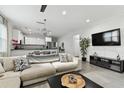 Open-concept living room flows into a modern kitchen with stainless steel appliances and sleek finishes at 4036 56Th N Ave, St Petersburg, FL 33714
