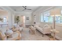 Bright living room with neutral decor, hardwood floors, a ceiling fan, and views of the front yard at 515 34Th Ne Ave, St Petersburg, FL 33704