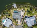 Exclusive waterfront property featuring a private dock, pool, lush landscaping, and expansive outdoor living spaces at 6614 Blackfin Way, Apollo Beach, FL 33572