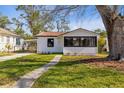 Inviting home with well-kept lawn, mature trees, and a concrete walkway leading to the entrance at 711 19Th S Ave, St Petersburg, FL 33705