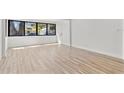 Bright living room with hardwood floors, clean white walls, and an expansive window at 711 19Th S Ave, St Petersburg, FL 33705