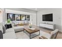 Bright living room with sleek furniture, large windows and light wood floors at 711 19Th S Ave, St Petersburg, FL 33705