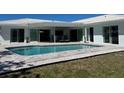 Inviting backyard pool and patio area, perfect for outdoor entertaining at 731 Snug Is, Clearwater, FL 33767