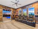 Theater room with comfortable seating, wet bar, and view to outdoor pool and spa at 7415 Paradiso Dr, Apollo Beach, FL 33572