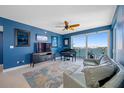 Bright living room with piano, slider to balcony, and ceiling fan at 7932 Sailboat Key S Blvd # 806, South Pasadena, FL 33707