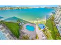 An elevated shot of the pool with surrounding chairs and well-maintained grass at 7932 Sailboat Key S Blvd # 806, South Pasadena, FL 33707