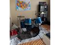 Bedroom with a drum set, gray area rug, and map of United States hanging on the wall at 9613 Jasmine Brook Crk, Land O Lakes, FL 34638