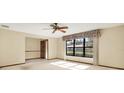 Bright bedroom with large window, ceiling fan, neutral carpet, and ensuite entrance at 10014 118Th Way, Seminole, FL 33772