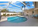 Inviting screened-in pool area with comfortable lounge chairs, perfect for relaxation and outdoor enjoyment at 10014 118Th Way, Seminole, FL 33772