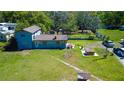 Aerial view of a two-story home with a picnic table, hot tub, and ample outdoor space for entertaining at 10034 Burton St, New Port Richey, FL 34654