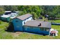Aerial view of a charming two-story home featuring a spacious backyard, ideal for outdoor activities and relaxation at 10034 Burton St, New Port Richey, FL 34654