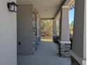 View of the stone-accented covered porch with views of the surrounding outdoors at 10240 Meadow Wren Ave, Weeki Wachee, FL 34613