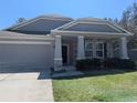 Inviting home with stone accents, covered porch, and an attached garage at 10240 Meadow Wren Ave, Weeki Wachee, FL 34613