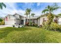 Beautiful single-story home with lush lawn, landscaping, and charming exterior at 1031 Ridge View Ln, Palm Harbor, FL 34683