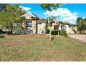 Inviting home with lush green lawn and a light green exterior at 12217 Trout Cir, Spring Hill, FL 34609