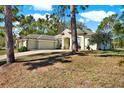 Well-maintained home with three-car garage and stone accents on a lush green lawn at 12217 Trout Cir, Spring Hill, FL 34609