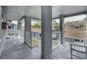 Outdoor patio space with railing, perfect for relaxing and enjoying the neighborhood views at 1438 Millstream Ln # 201, Dunedin, FL 34698