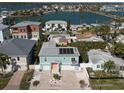Aerial view of a charming coastal home with solar panels and proximity to a beautiful bay at 16109 3Rd E St, Redington Beach, FL 33708