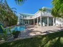 Backyard featuring a beautiful pool, lush tropical landscaping, spacious deck perfect for entertaining at 16109 3Rd E St, Redington Beach, FL 33708