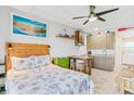 Comfortable living space with a kitchenette, table with stools, and bed with beach-themed decor for a relaxing retreat at 18399 Gulf Blvd # 389, Indian Shores, FL 33785