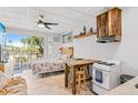 Cozy living space featuring kitchenette, dining table, and a comfortable bed with access to a balcony with outdoor furniture at 18399 Gulf Blvd # 389, Indian Shores, FL 33785