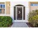 Close-up of the home's front entrance, featuring a decorative security door with a heron design at 1922 Sifield Greens Way # 47, Sun City Center, FL 33573