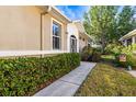 Attractive front exterior with well-maintained landscaping, walkway and a glimpse of an decorative front door at 1922 Sifield Greens Way # 47, Sun City Center, FL 33573