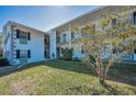 Well-maintained two-story building features lush landscaping and a pleasant facade at 200 Glennes Ln # 201, Dunedin, FL 34698