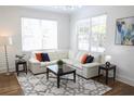 Cozy living room with a large sectional sofa, stylish rug, and plenty of natural light at 205 N Westland Ave, Tampa, FL 33606