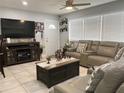 Comfortable living room with tile floors, a plush gray sectional, and a large television for entertainment at 21298 Austin Ave, Port Charlotte, FL 33952