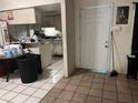 Living and dining area featuring tile floor, white walls, and views to the kitchen at 2610 E 26Th Ave, Tampa, FL 33605