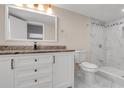 Updated bathroom featuring a marble tile shower and modern vanity at 2702 W Braddock St, Tampa, FL 33607