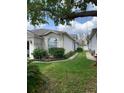 Charming single-story home featuring a two-car garage and well-maintained landscaping at 30049 Emmetts Ct, Wesley Chapel, FL 33543