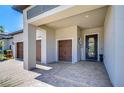 Exterior front entrance of house with brick driveway and pathway, and front door with glass at 31452 Cabana Rye Ave, San Antonio, FL 33576