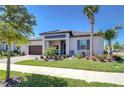 A well-maintained single-story home featuring lush landscaping, brick driveway, and a welcoming entrance at 31452 Cabana Rye Ave, San Antonio, FL 33576