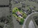 Bird's-eye view of the property displaying the landscaped yard, pool, and well-maintained exterior at 34201 Kentucky Derby Pl, Dade City, FL 33525