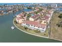 Breathtaking aerial view of a waterfront condo with private dock, landscaping, and waterfront access at 553 Haven Point Dr, Treasure Island, FL 33706