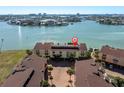 A beautiful aerial view of condos with water views and palm trees at 553 Haven Point Dr, Treasure Island, FL 33706
