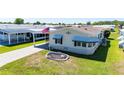 An inviting home with a well-kept lawn, covered parking and a decorative circular garden bed at 5745 Pawnee St, Zephyrhills, FL 33542