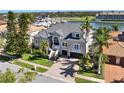 Beautiful home with well-manicured lawn, palm trees, and a two-car garage at 6113 Pasadena Point Blvd, Gulfport, FL 33707