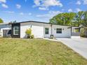 Charming one-story home boasts a freshly painted exterior, modern accents, and a well-manicured lawn at 6508 S West Shore Cir, Tampa, FL 33616