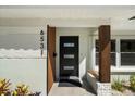 Modern front door with sidelight and brick accents, enhancing curb appeal at 6531 2Nd N Ave, St Petersburg, FL 33710